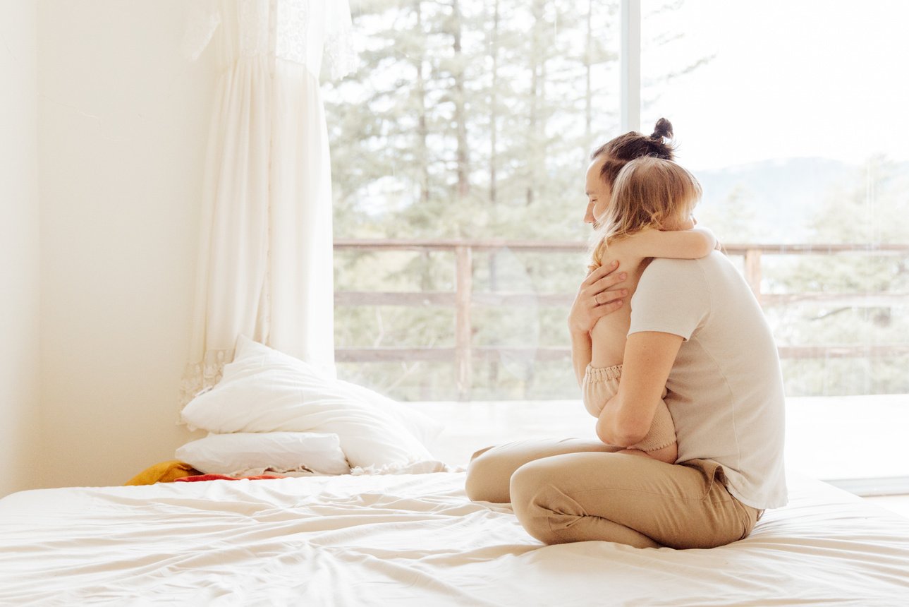 Photo Of Man Embracing Child